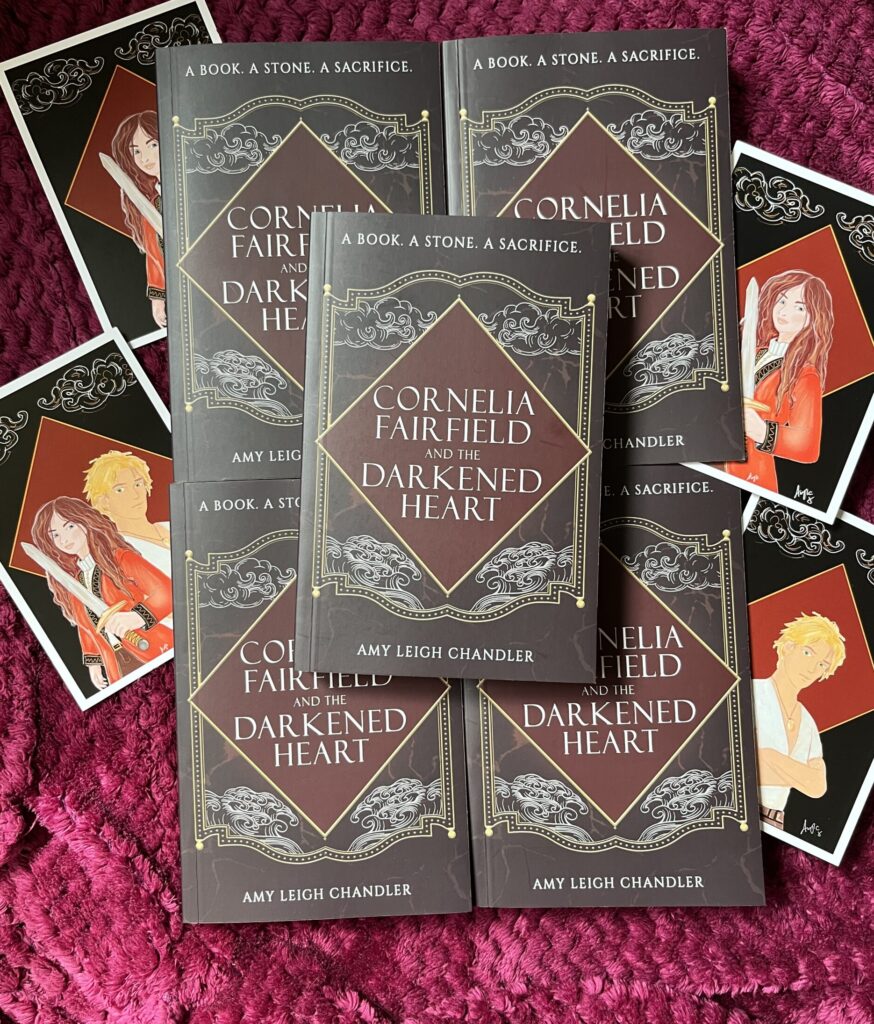 Amy Leigh Chandler's debut novel, CORNELIA FAIRFIELD AND THE DARKENED HEART is published today (19 May 2026) it's filled with high stakes adventure, slow burn romance between a superstitious pirate and a rebellious noble, a deadly curse and a dangerous bargain. Available in paperback and ebook with an exclusive bonus chapter only on Kindle. Waterstones, Bookshop.org, Amazon and independent bookshops.